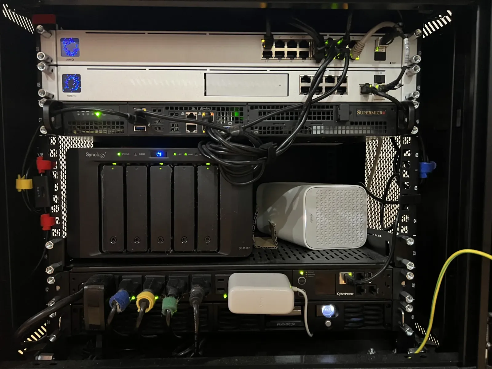 The rack before: a Supermicro 1U, Synology DS1515+, and the rest of the fleet.